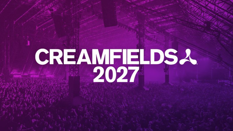 Creamfields 2027 key art: the Creamfields 2027 logo over a packed crowd under an indoor stage roof