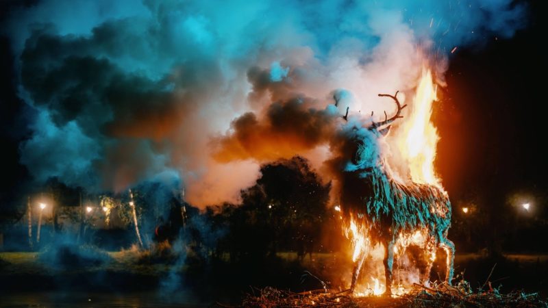 Lost Village festival burning stag sculpture by the lake at night